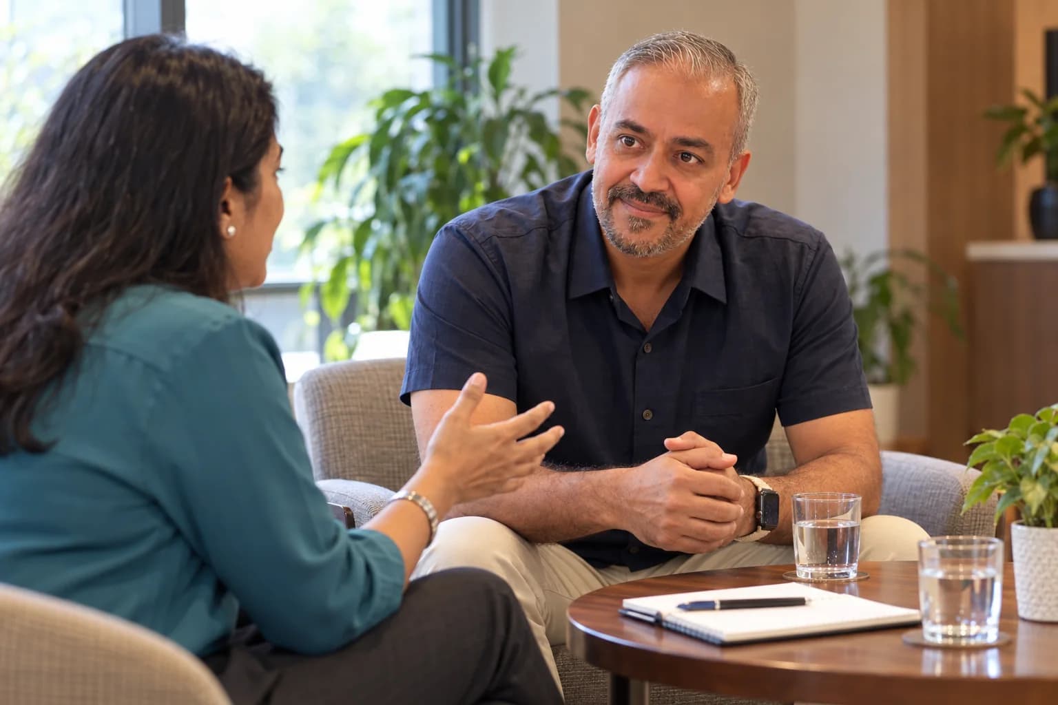 Two colleagues share perspectives during a focused workplace conversation.